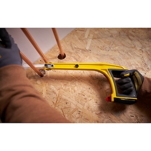 STANLEY 0-20-108 hacksaw cutting copper pipe, angled close-up photography, yellow frame, ergonomic handle.
