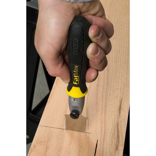STANLEY 0-20-331 FatMax saw with black and yellow handle cutting wood, close-up photography.