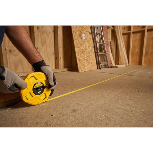 Photo of STANLEY 0-34-297 measuring tape being used on a construction site floor.