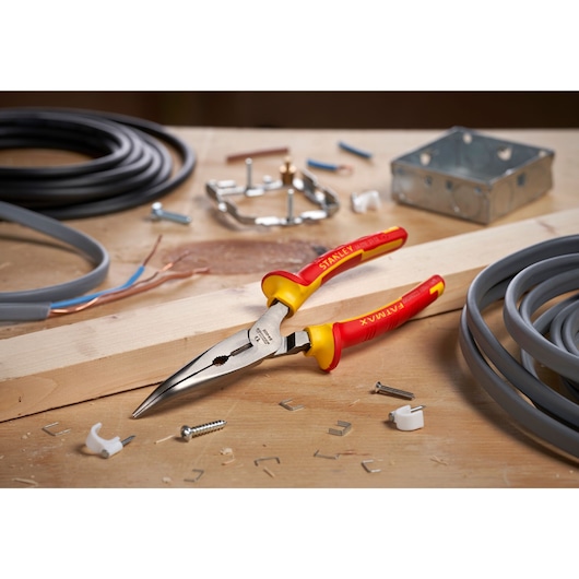 STANLEY 0-84-008 insulated long nose pliers on a workbench with cables and electrical parts.