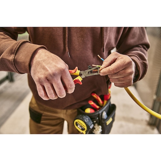 STANLEY 0-84-010 pliers used to strip electrical wire, tool pouch visible, close-up photography.