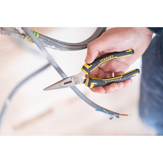 Stanley 0-89-869 FatMax long nose pliers held cutting electrical wire, photography, close-up view.