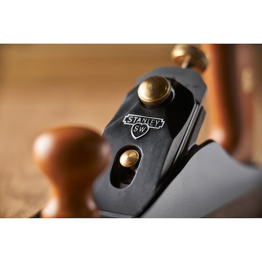 Photo of STANLEY 1-12-136 hand plane, close-up showing branded logo, brass fittings, and wooden handle.