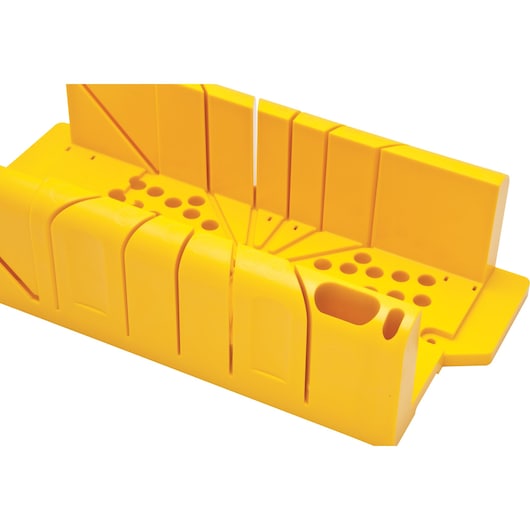 Yellow plastic Stanley mitre box with slots and holes for precise angled cutting of wood or materials.