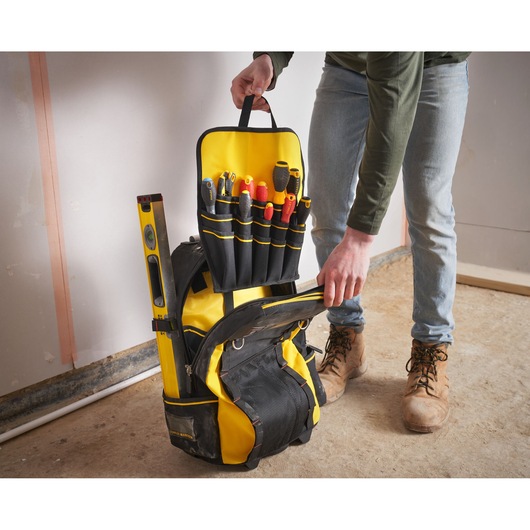 STANLEY 1-79-215 tool backpack with yellow and black design, open to show organized tools and level.