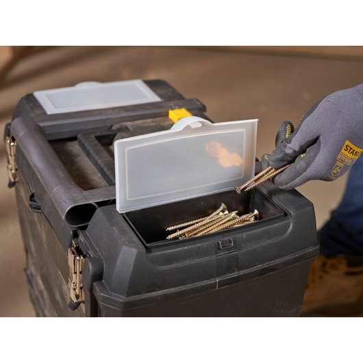STANLEY 1-93-968 toolbox close-up with open top compartment, screws inside, gloved hand removing screws.