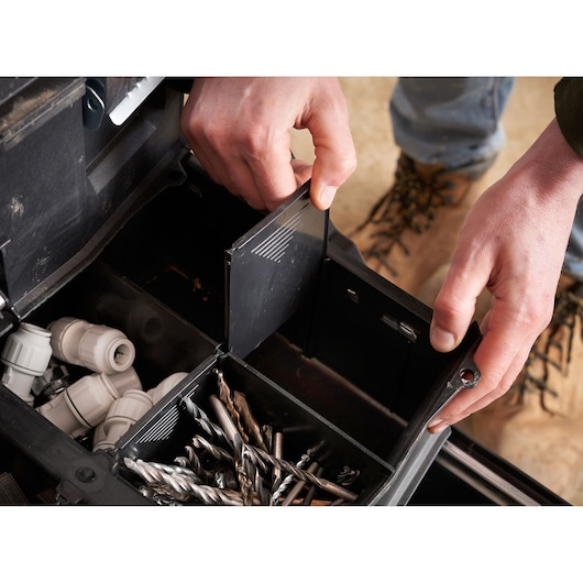 STANLEY 1-94-210 toolbox interior with compartments holding drill bits and plastic fittings, close-up.