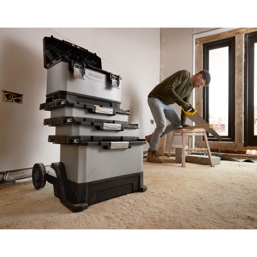 Photo of STANLEY 1-95-622 rolling tool chest stack in a workshop, showing four grey and black toolboxes with wheels.