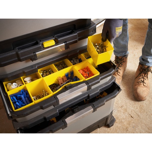 STANLEY 1-95-622 organizer with multiple yellow compartments holding screws and connectors, top-view angle.