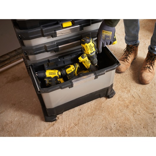 STANLEY 1-95-622 tool box with open drawer showing power tools and a person wearing STANLEY gloves.