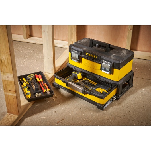 STANLEY 1-95-829 yellow and black toolbox with open tray showing hand tools, photography on worksite.