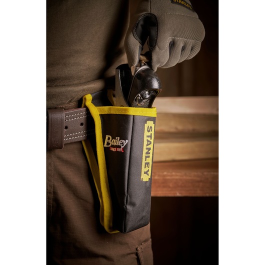 STANLEY 12-020 hand plane in branded holster on tool belt, close-up side view.