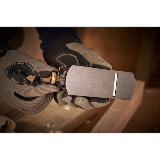 Photo of STANLEY 12-020 block plane held in gloved hands, woodwork setting visible.
