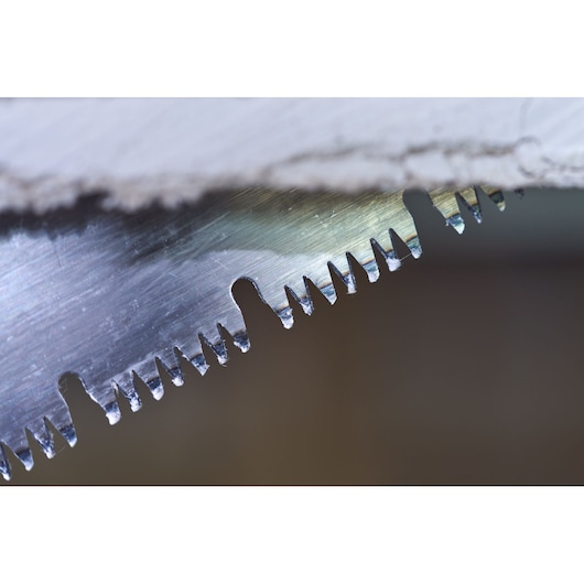 STANLEY 2-20-037 close-up photo of saw blade teeth cutting through white material.
