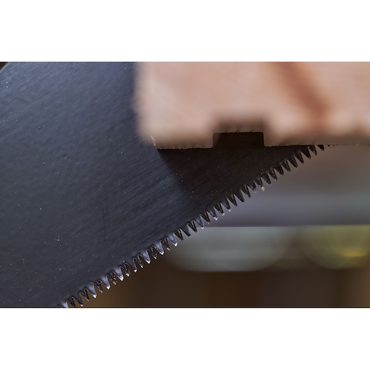 STANLEY 2-20-180 handsaw blade close-up photography with sharp teeth cutting wood.