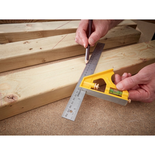 Photo of STANLEY 2-46-028 combination square used to mark lines on wooden boards.