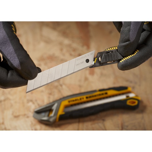 Photo of STANLEY 3-11-301 snap-off utility knife blade being replaced, with gloves holding the blade.