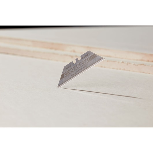 Photo of STANLEY 8-11-800 utility blade on white background, sharp edge visible, product photography angle.