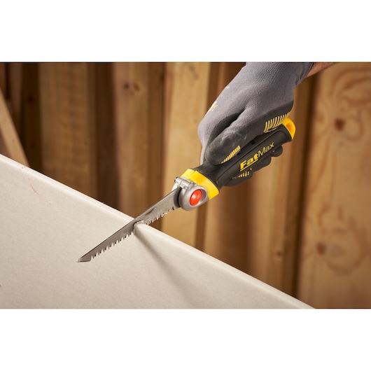 STANLEY FMHT0-20559 drywall saw with ergonomic handle in use, close-up side angle.