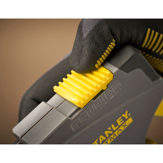 STANLEY FMHT6-70868 photography of yellow and gray tool closeup with gloved hand adjusting yellow slider.