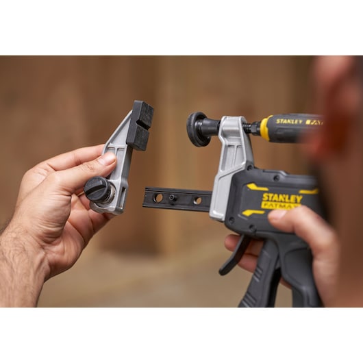 STANLEY FMHT83007-0 photography, close-up of clamp tool with removable jaw, hands holding parts.