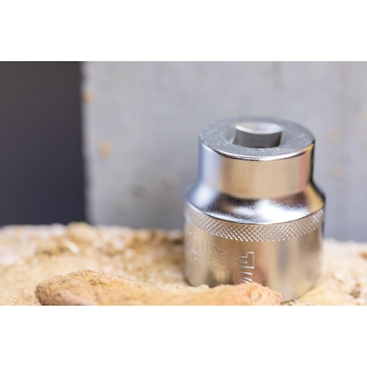 STANLEY FMMT82681-0 chrome socket tool on a sandy surface, close-up photography.