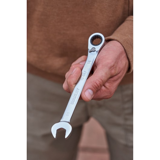 Photo of STANLEY FMMT82848-0 reversible ratcheting wrench held in hand, silver finish, 14mm size visible.