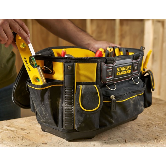 STANLEY FMST1-70749 tool bag with yellow trim filled with hand tools, front angle photo.