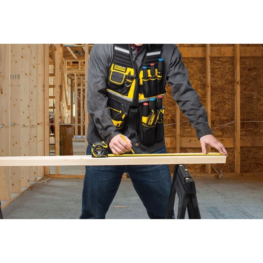 STANLEY FMST1-71181 tool vest with pockets, worn by person in construction setting.