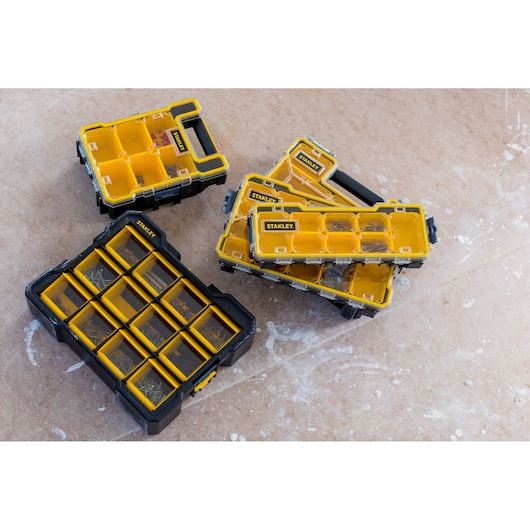 STANLEY FMST81077-1 organizer boxes with yellow compartments on a workshop floor, photography, top view.