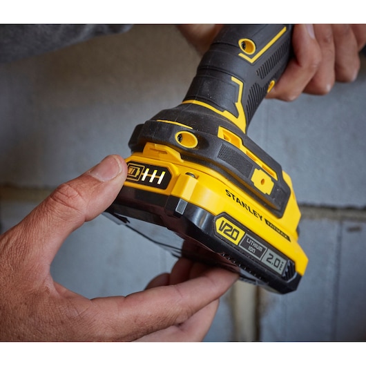 Photo of STANLEY SFMCB202 V20 Lithium Ion 2.0Ah battery attached to yellow and black power tool.