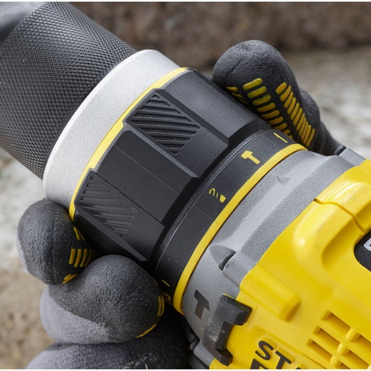 STANLEY SFMCD721B drill close-up showing grip and adjustable torque settings, with gloved hand holding tool.