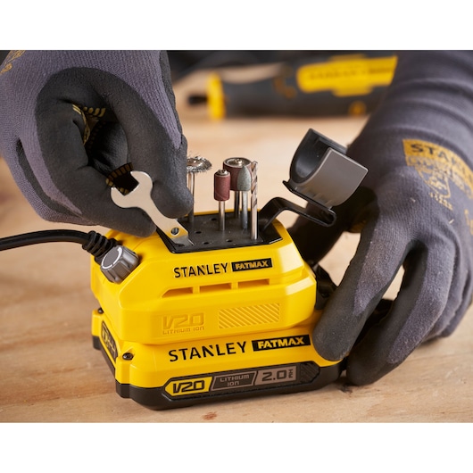 STANLEY SFMCE030B rotary tool with drill bits and accessories inserted, close-up on workbench.