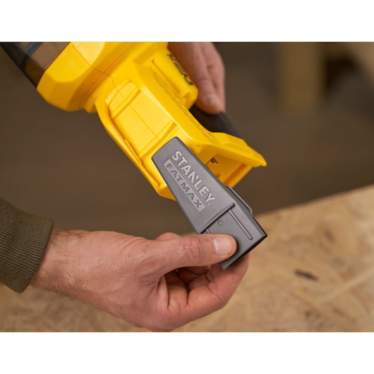 STANLEY SFMCVH001B vacuum battery being inserted into yellow handheld tool, close-up view.