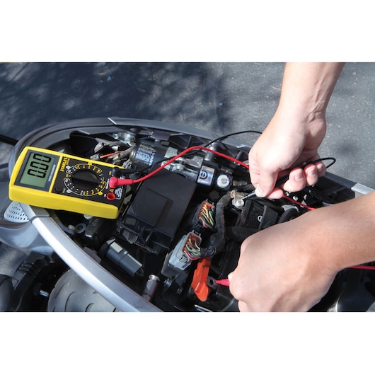 STANLEY STHT0-77364 digital multimeter testing vehicle wiring, yellow device, photography category.