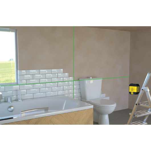 STANLEY STHT77499-1 laser level projecting green lines in a bathroom for tile installation, front angle.