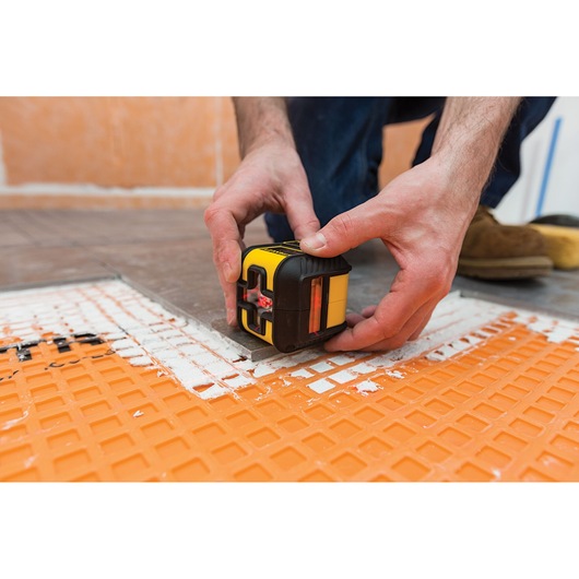 Photo of STANLEY STHT77502-1 laser level tool used for floor tiling alignment.