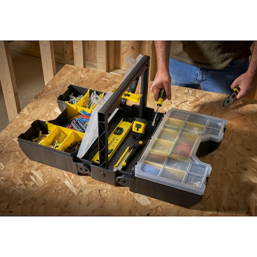 STANLEY STST1-71963 tool box open with compartments filled on workbench, photographed from above.